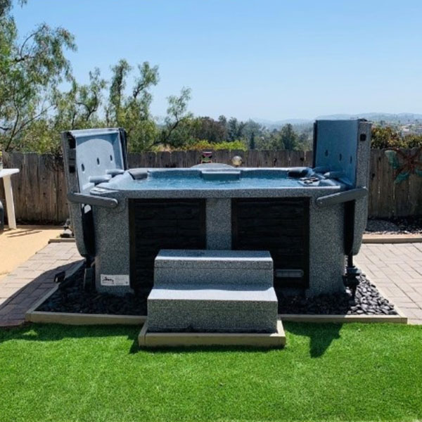 An open eco spa with stairs in a landscaped yard